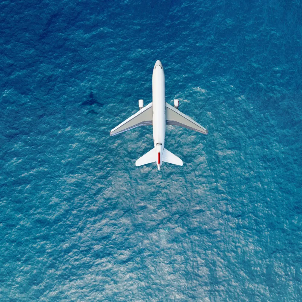 Airplane flies over a sea